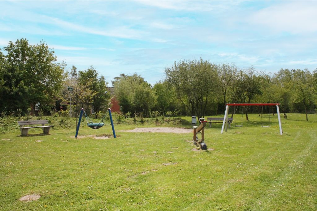 Urlauberdorf - Blick auf den Spielplatz hinter den Häusern 54-55